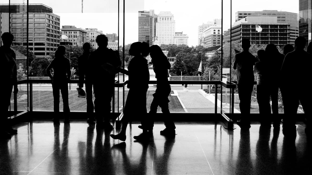 silhouettes of crowd inside a building