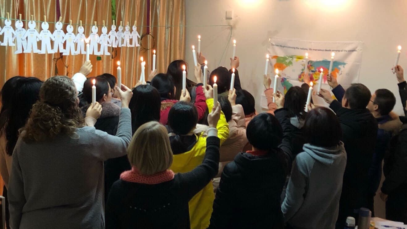 group of people holding up candles