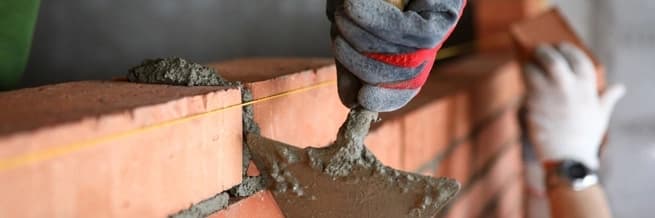 person laying bricks