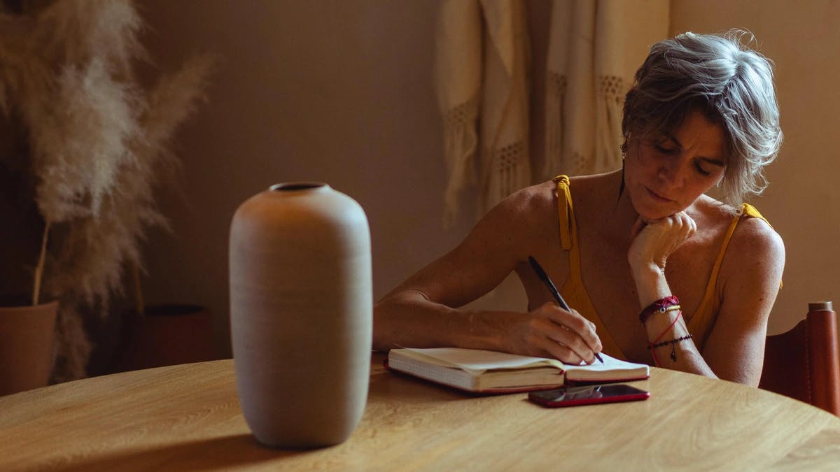 woman journaling on table