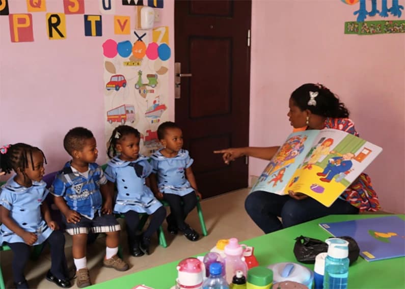 teacher reading book to students