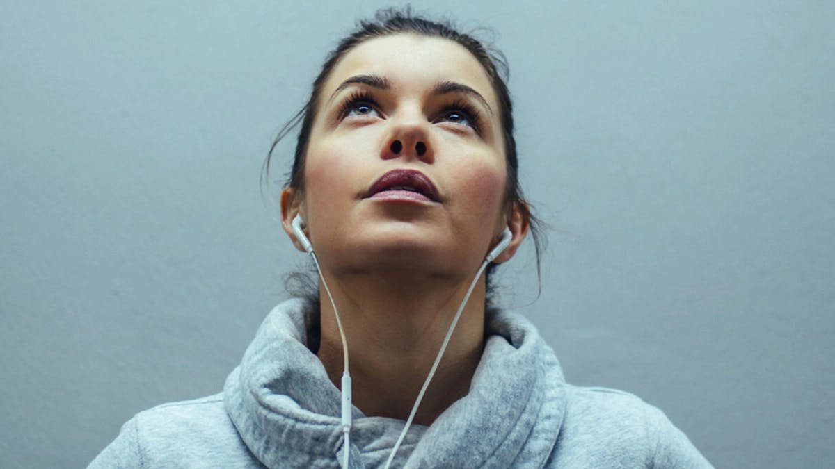 woman athlete looking up with headphones