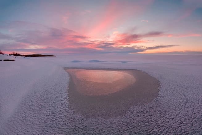 heart shaped wet spot on a a stretch of sand