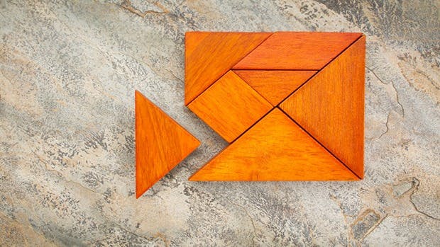 orange wooden blocks fitting together to form a rectangular shape on a countertop, one block slightly pulled away and not quite fitting.