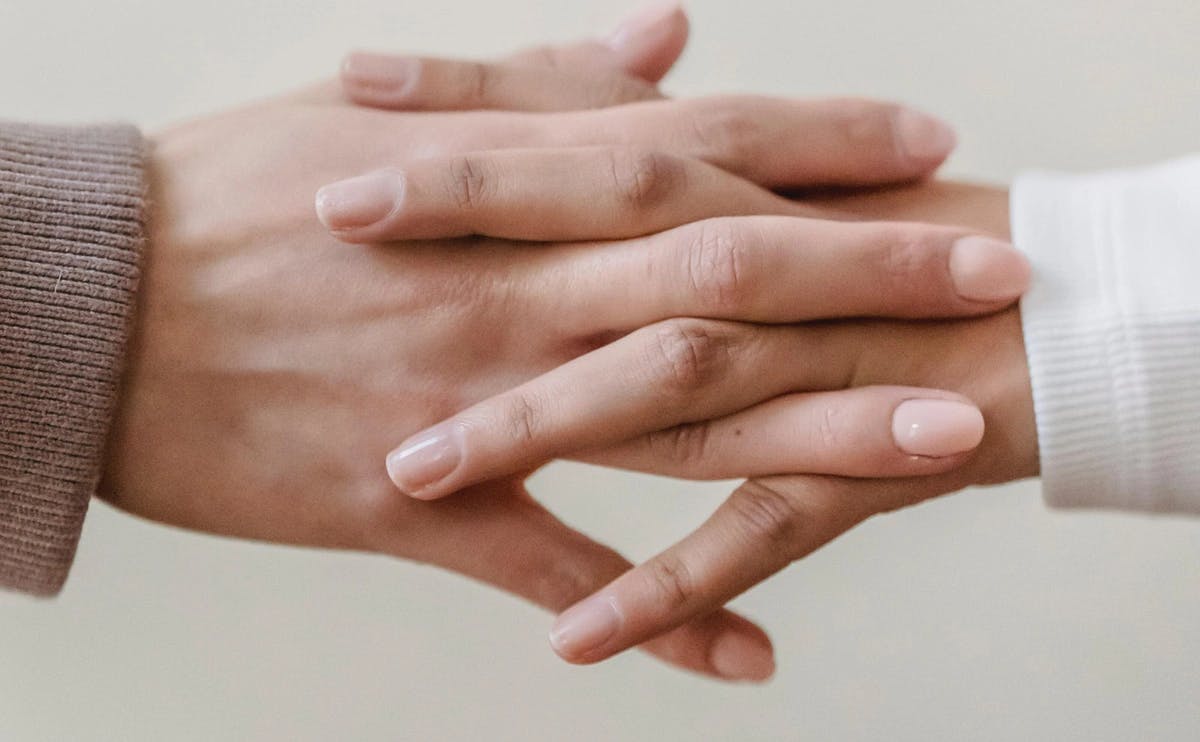 hands with intertwined fingers